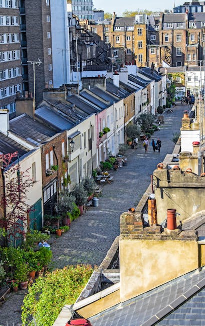 A row of elegant terraced homes on Marylebone High Street features classic British architecture with white and brick facades, tall sash windows, and ornate black wrought-iron balconies. The building i